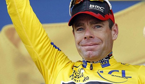 BMC Racing Team's Evans of Australia wears the leader's yellow jersey on the podium after the 20th time trial stage in Grenoble during the Tour de France cycling race